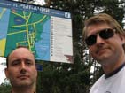 Team posing in front of tourist information in Ribachy village.