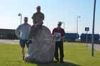Karsten, Tom and Soren in front of Local Stone at Fej� (Fejoe) - with News Paper (see also background)